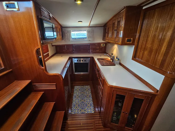 Ballena Yacht Photos Pics Luxurious wooden interior of 2002 Grand Banks 49 Eastbay HX yacht kitchen.