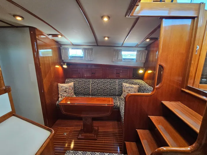 Ballena Yacht Photos Pics Luxurious 2002 Grand Banks 49 Eastbay HX yacht interior with elegant wood finish and cozy seating.