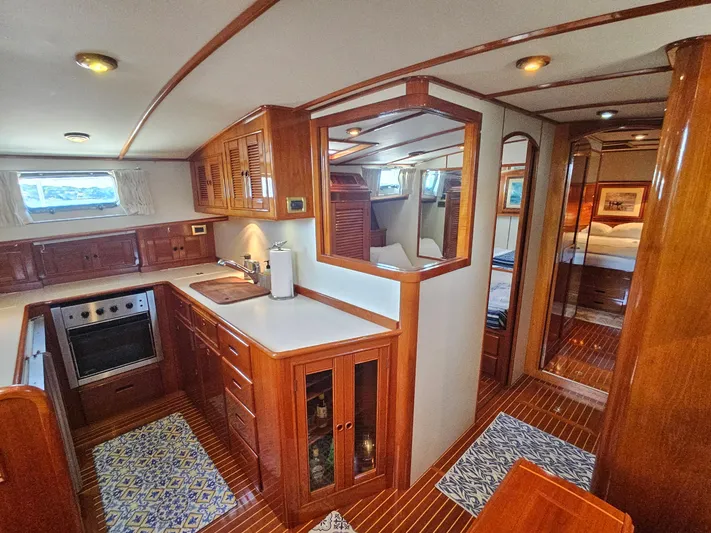 Ballena Yacht Photos Pics Luxurious 2002 Grand Banks 49 Eastbay HX yacht interior with wood cabinetry and modern kitchen.
