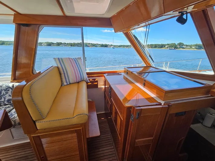 Ballena Yacht Photos Pics Interior of 2002 Grand Banks 49 Eastbay HX yacht with wooden finish and scenic water view.