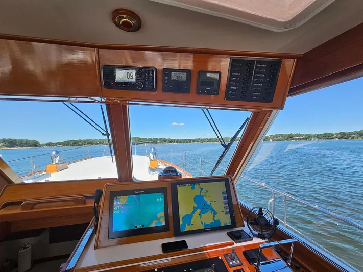 Ballena Yacht Photos Pics Helm view of 2002 Grand Banks 49 Eastbay HX yacht with navigation screens and scenic waterway.