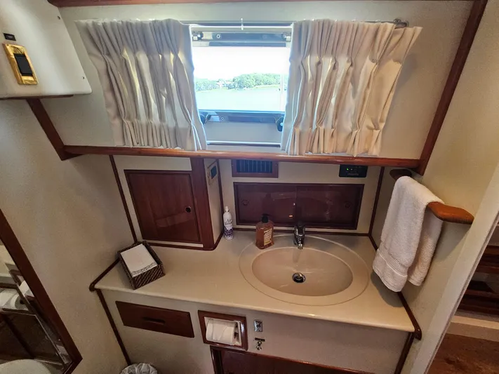 Ballena Yacht Photos Pics Bathroom interior of 2002 Grand Banks 49 Eastbay HX yacht with sink and window.