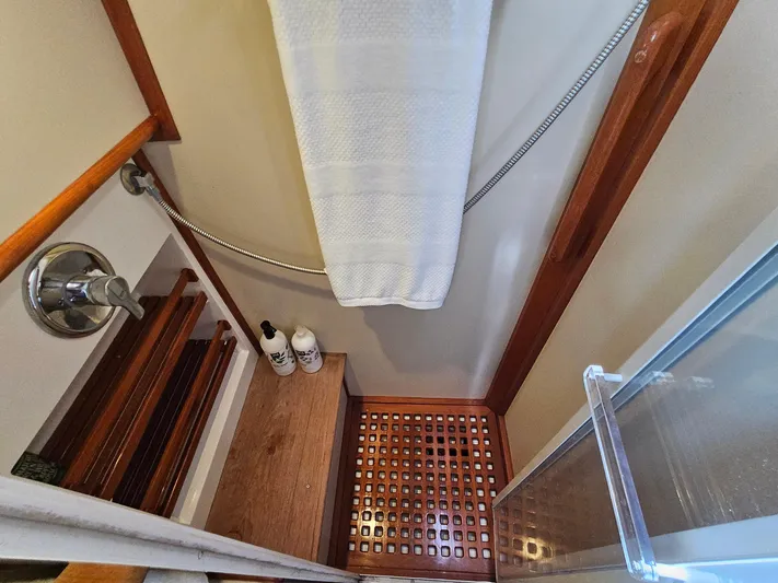 Ballena Yacht Photos Pics Shower area in 2002 Grand Banks 49 Eastbay HX yacht with wooden accents and toiletries.