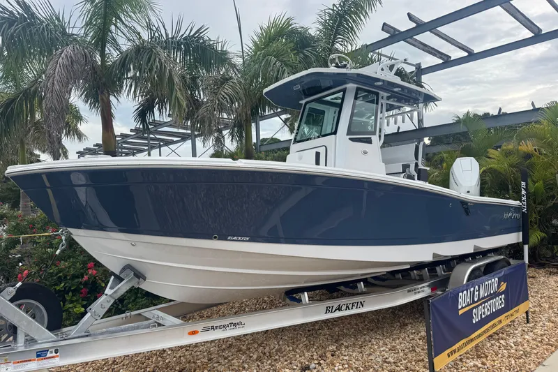  Yacht Photos Pics 2026 Blackfin 262 HB boat on trailer, surrounded by palm trees.