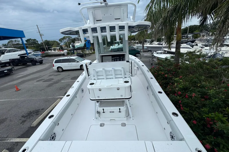  Yacht Photos Pics 2026 Blackfin 262 HB boat in marina, surrounded by vehicles and greenery.