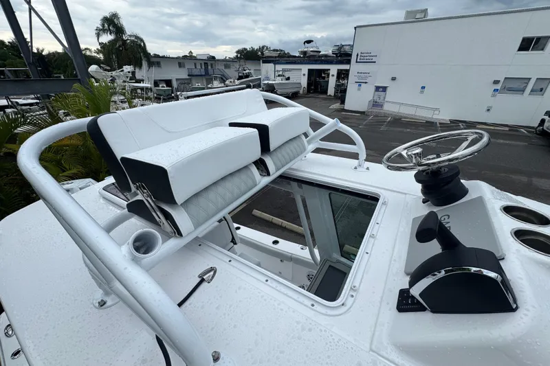  Yacht Photos Pics 2026 Blackfin 262 HB boat helm with steering wheel and seating, in a marina setting.
