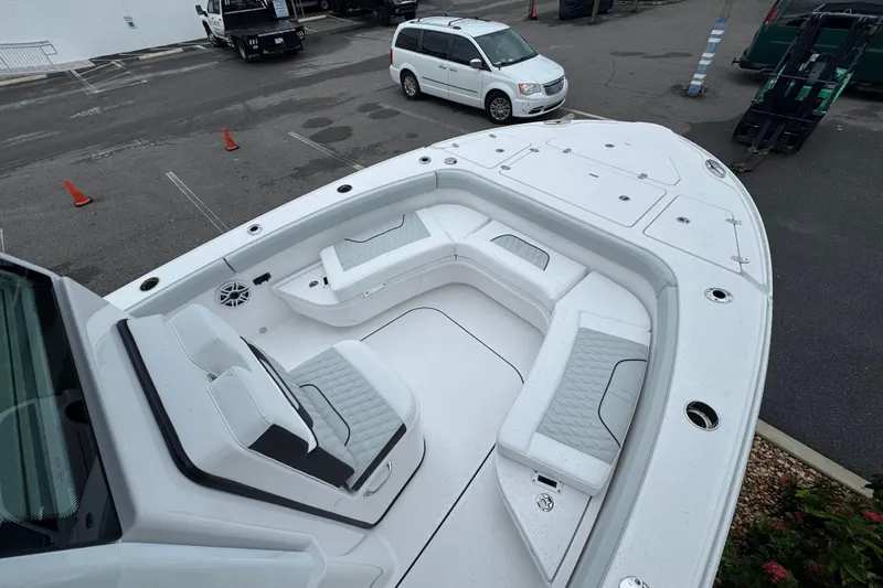  Yacht Photos Pics 2026 Blackfin 262 HB boat with spacious seating and modern design in a parking area.