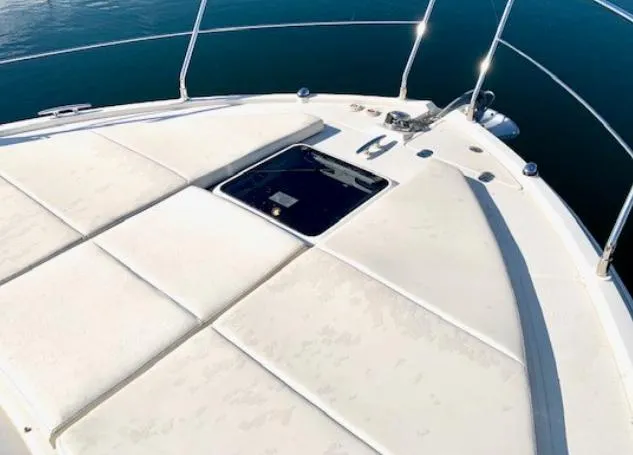  Yacht Photos Pics 2016 Carver C37 yacht bow with sunpad and hatch, on calm water.