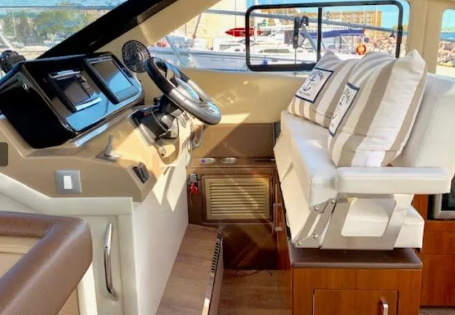  Yacht Photos Pics Helm of 2016 Carver C37 yacht with steering wheel and cushioned seating.