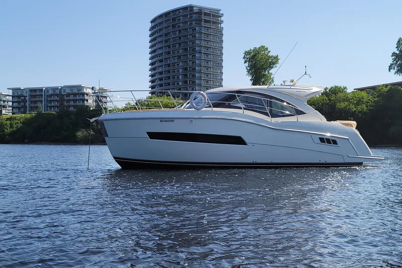  Yacht Photos Pics 2016 Carver C37 yacht on water with modern buildings in the background.