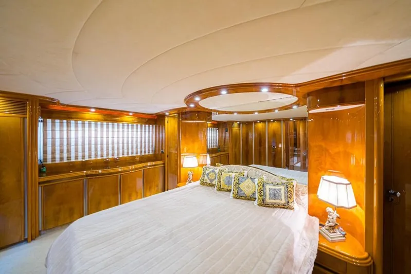  Yacht Photos Pics Luxurious bedroom interior of 2000 Astondoa 82 GLX yacht with elegant wood paneling and ambient lighting.