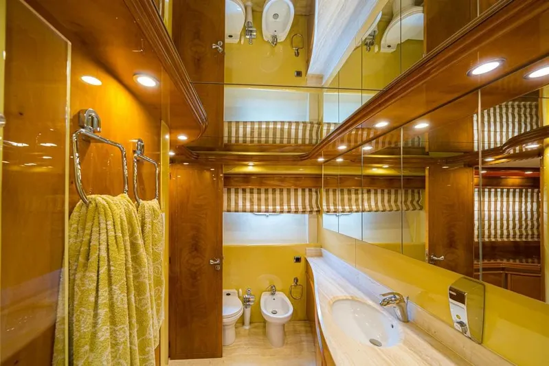  Yacht Photos Pics Luxurious bathroom in 2000 Astondoa 82 GLX yacht with wood accents and modern fixtures.