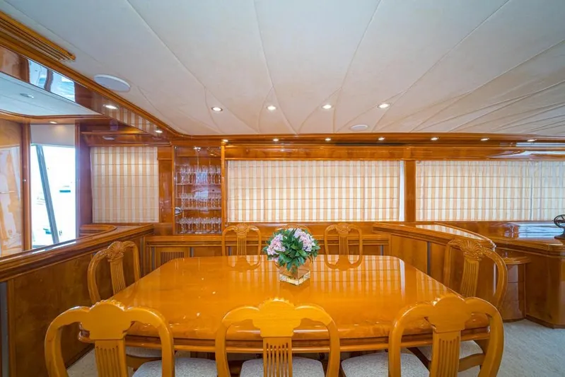  Yacht Photos Pics Luxurious dining area on 2000 Astondoa 82 GLX yacht with elegant wooden table and chairs.