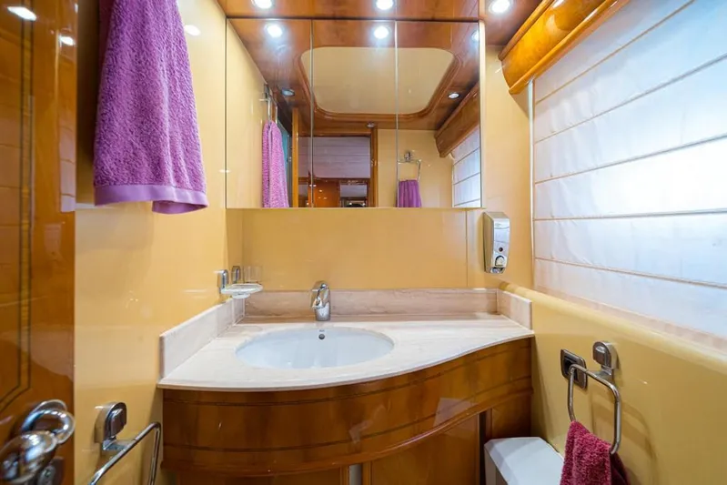  Yacht Photos Pics Luxurious bathroom in 2000 Astondoa 82 GLX yacht with elegant wood and modern fixtures.
