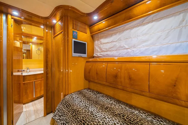  Yacht Photos Pics Luxurious cabin interior of 2000 Astondoa 82 GLX yacht with wood finish and leopard print bedding.