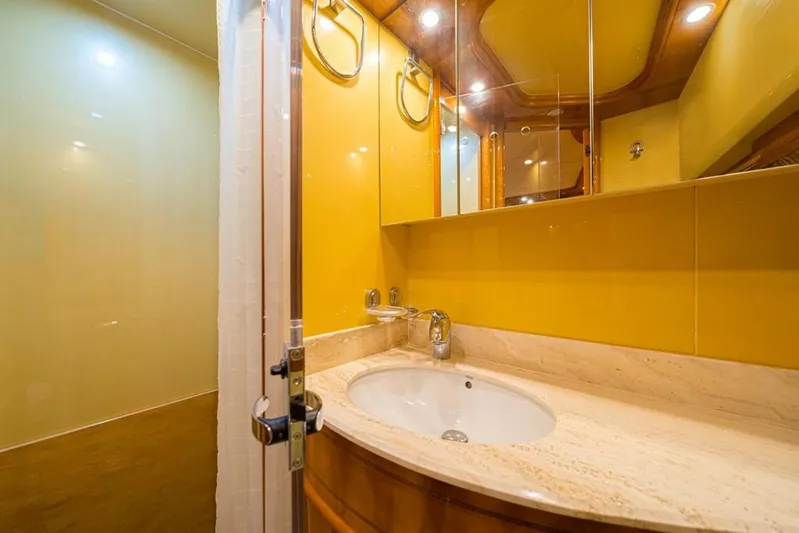  Yacht Photos Pics Luxurious bathroom in 2000 Astondoa 82 GLX yacht with yellow walls and marble countertop.