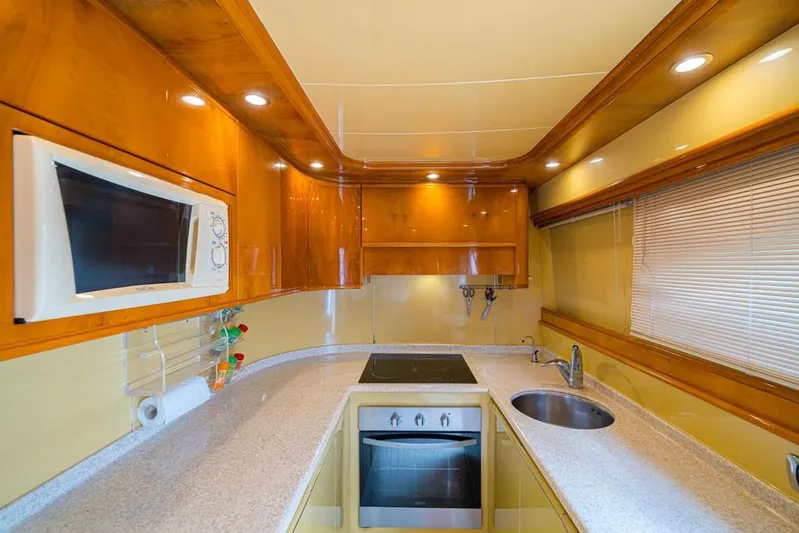  Yacht Photos Pics Luxurious kitchen in 2000 Astondoa 82 GLX yacht with modern appliances and sleek design.