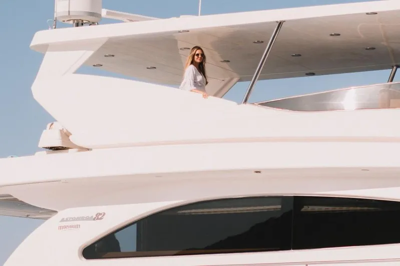  Yacht Photos Pics Woman on deck of 2000 Astondoa 82 GLX yacht, enjoying sunny day.