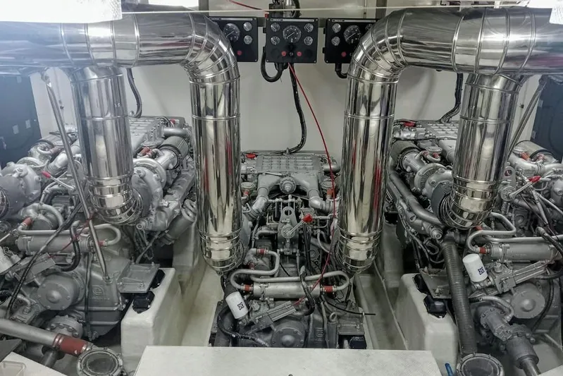 Yacht Photos Pics Engine room of 2000 Astondoa 82 GLX yacht with dual engines and polished exhaust pipes.