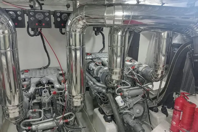  Yacht Photos Pics Engine room of 2000 Astondoa 82 GLX yacht with dual engines and fire extinguishers.
