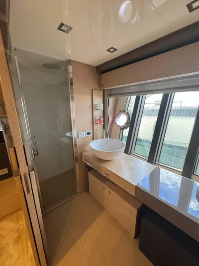  Yacht Photos Pics Luxurious bathroom in 2016 Ferretti Yachts 750 with modern fixtures and large windows.