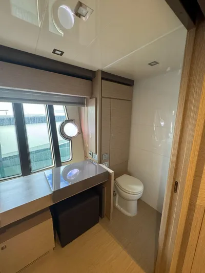  Yacht Photos Pics Luxurious bathroom in 2016 Ferretti Yachts 750 with modern fixtures and large window.
