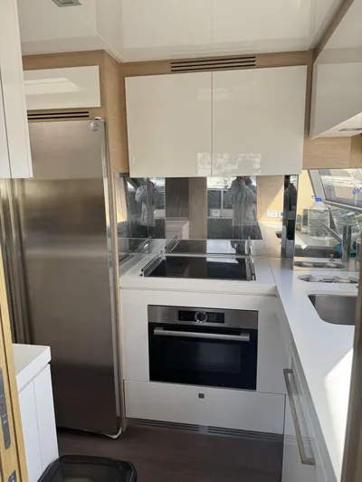 Yacht Photos Pics Modern kitchen interior on 2016 Ferretti Yachts 750, featuring sleek appliances and cabinetry.