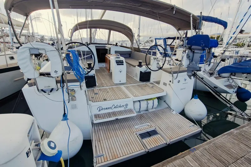Dreamcatcher II Yacht Photos Pics 2019 Jeanneau Sun Odyssey 440 sailboat docked at marina, featuring spacious deck and dual steering wheels.