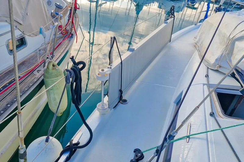 Dreamcatcher II Yacht Photos Pics 2019 Jeanneau Sun Odyssey 440 sailboat deck with docked boats and reflections.