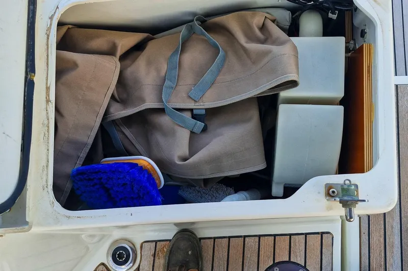 Dreamcatcher II Yacht Photos Pics Storage compartment on a 2019 Jeanneau Sun Odyssey 440 sailboat with cleaning supplies.
