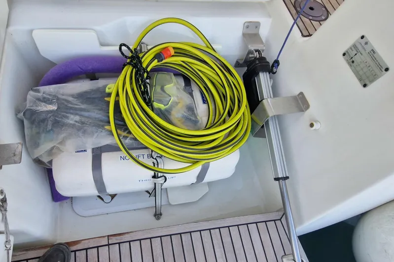 Dreamcatcher II Yacht Photos Pics Storage compartment on 2019 Jeanneau Sun Odyssey 440 with coiled yellow cable and equipment.