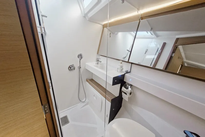Dreamcatcher II Yacht Photos Pics Modern bathroom in 2019 Jeanneau Sun Odyssey 440 yacht, featuring sleek fixtures and ample lighting.