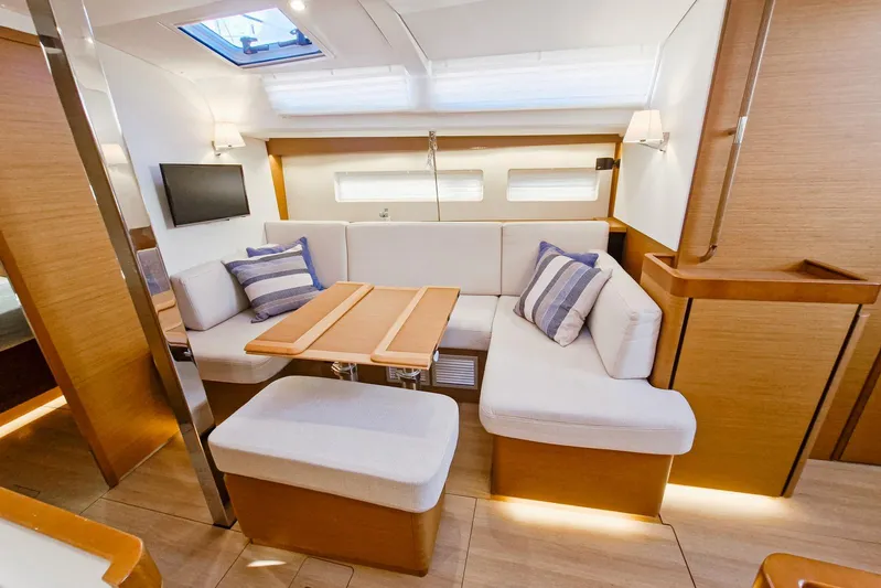 Dreamcatcher II Yacht Photos Pics Luxurious interior of 2019 Jeanneau Sun Odyssey 440 yacht with cozy seating and modern decor.