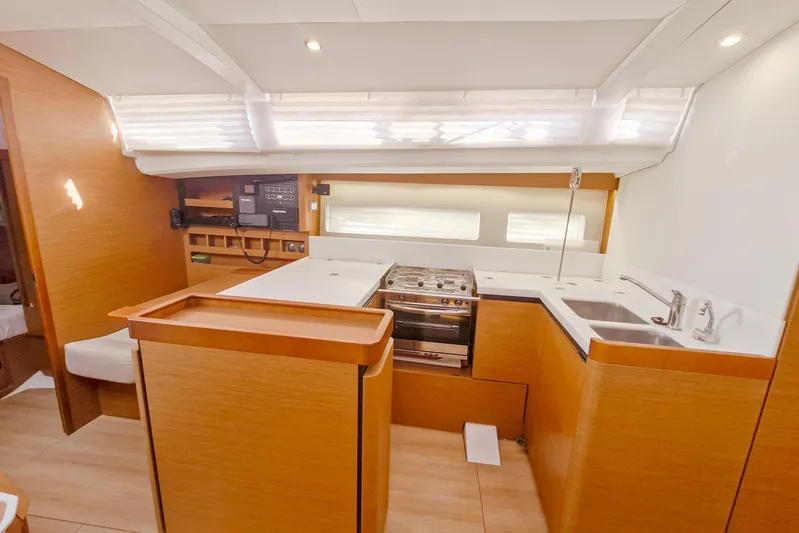 Dreamcatcher II Yacht Photos Pics Interior of 2019 Jeanneau Sun Odyssey 440 yacht, featuring modern kitchen and wood finishes.