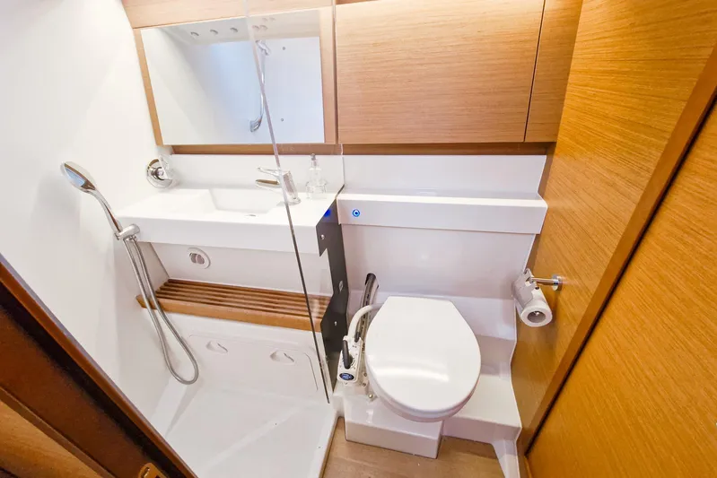 Dreamcatcher II Yacht Photos Pics Modern bathroom in 2019 Jeanneau Sun Odyssey 440 yacht, featuring sleek design and wooden accents.