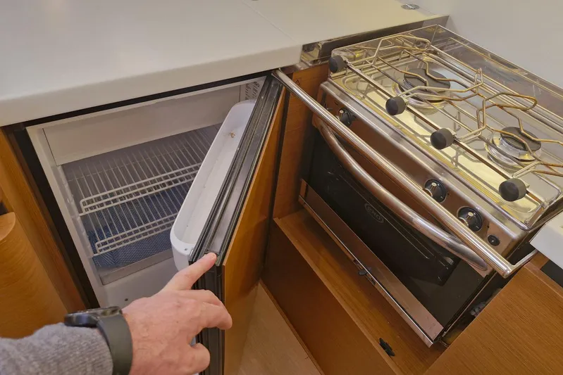 Dreamcatcher II Yacht Photos Pics Compact kitchen in 2019 Jeanneau Sun Odyssey 440 yacht with fridge and stove.