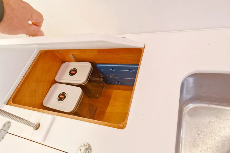 Dreamcatcher II Yacht Photos Pics Storage compartment on Jeanneau Sun Odyssey 440 yacht, featuring containers and a sink.