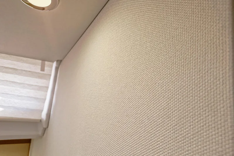 Dreamcatcher II Yacht Photos Pics Interior detail of 2019 Jeanneau Sun Odyssey 440 yacht, featuring textured wall and ceiling light.