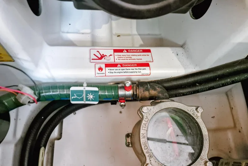 Dreamcatcher II Yacht Photos Pics Engine compartment of 2019 Jeanneau Sun Odyssey 440 with safety warning labels.