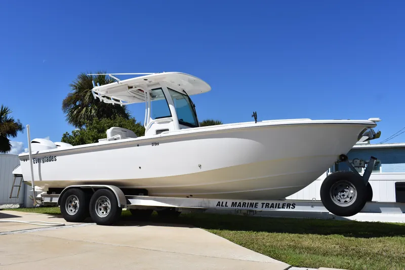  Yacht Photos Pics 2018 Everglades 273 Center Console boat on trailer, parked outdoors.