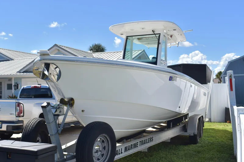  Yacht Photos Pics 2018 Everglades 273 Center Console boat on trailer, parked in residential area.