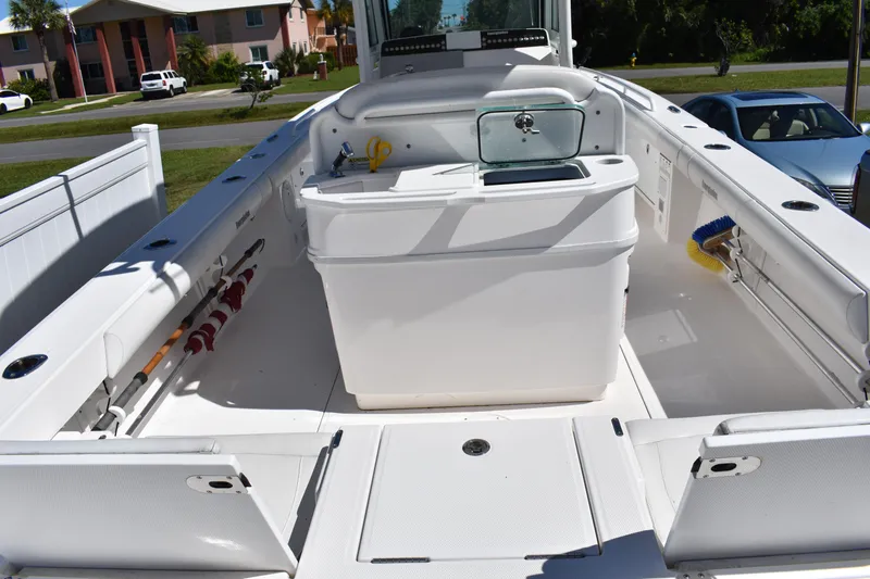  Yacht Photos Pics 2018 Everglades 273 Center Console boat interior with fishing gear and storage compartments.