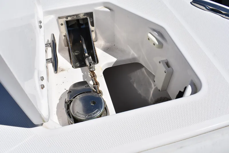  Yacht Photos Pics Anchor compartment of 2018 Everglades 273 Center Console boat, featuring a chain and winch.