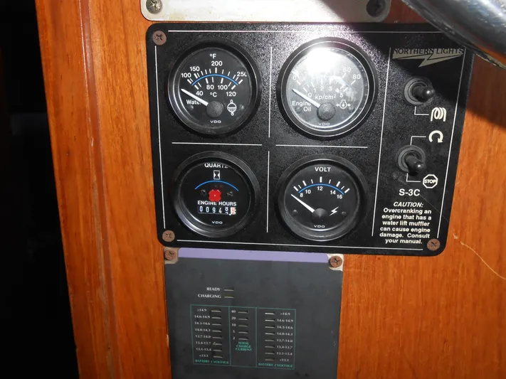 Ahoy Vey Yacht Photos Pics Control panel of 1978 CHB 34 Aft Cabin boat with gauges and warning labels.