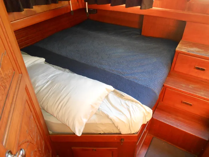Ahoy Vey Yacht Photos Pics Cozy cabin bedroom in 1978 CHB 34 Aft Cabin boat with wooden interior.