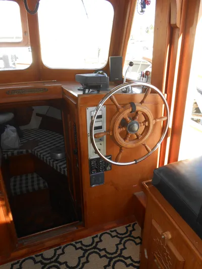 Ahoy Vey Yacht Photos Pics 1978 CHB 34 Aft Cabin helm with wooden wheel and cabin interior.