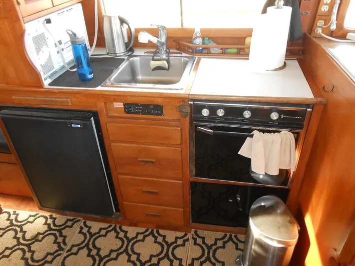 Ahoy Vey Yacht Photos Pics 1978 CHB 34 Aft Cabin kitchen with sink, stove, and fridge.