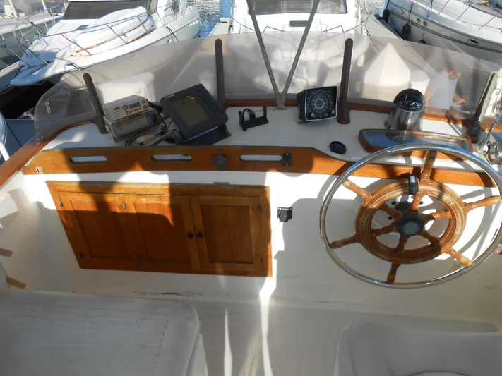 Ahoy Vey Yacht Photos Pics 1978 CHB 34 Aft Cabin helm with wooden wheel and navigation instruments.