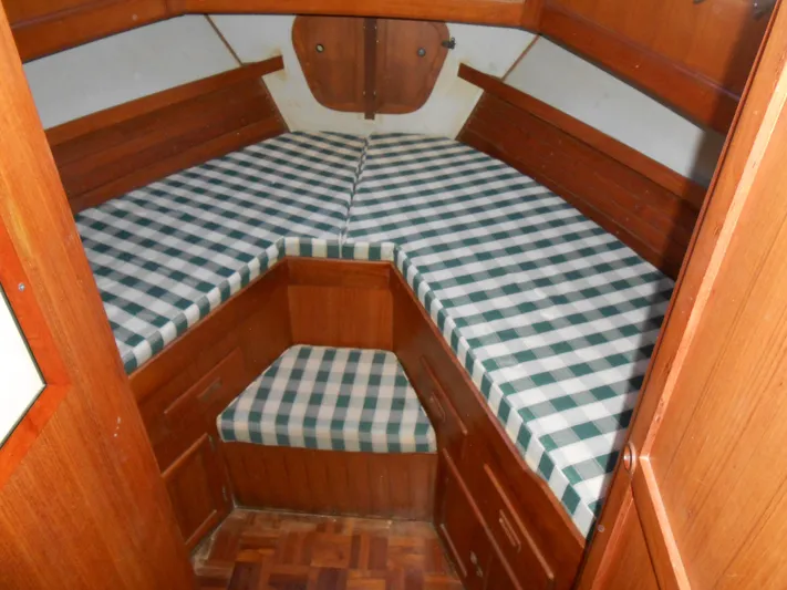 Ahoy Vey Yacht Photos Pics 1978 CHB 34 Aft Cabin interior with checkered bedding and wooden cabinetry.