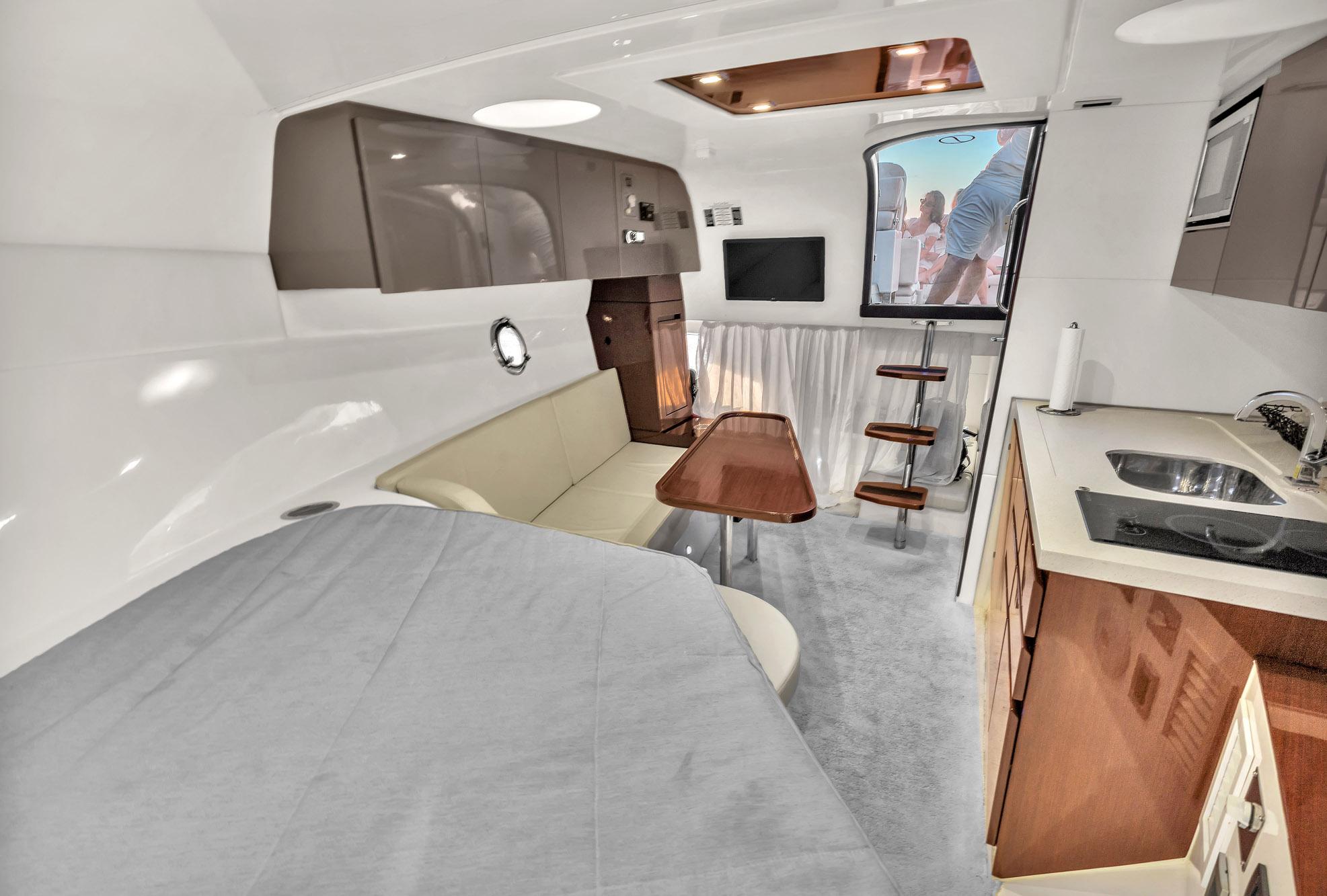 Interior of 2023 Schaefer 375 yacht with modern kitchen, seating, and dining area.